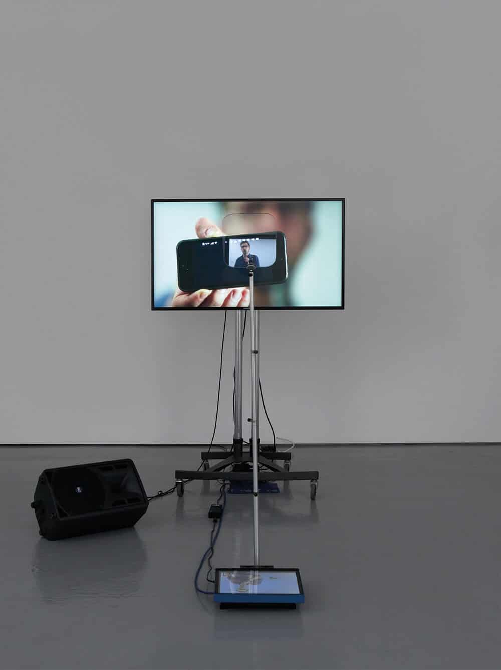 Lawrence Abu Hamdan, Contra Diction (speech against itself), 2015. Two channel video installation, teleprompter, screen, speaker variable dimensions. © Lawrence Abu Hamdan. Courtesy Maureen Paley, London.