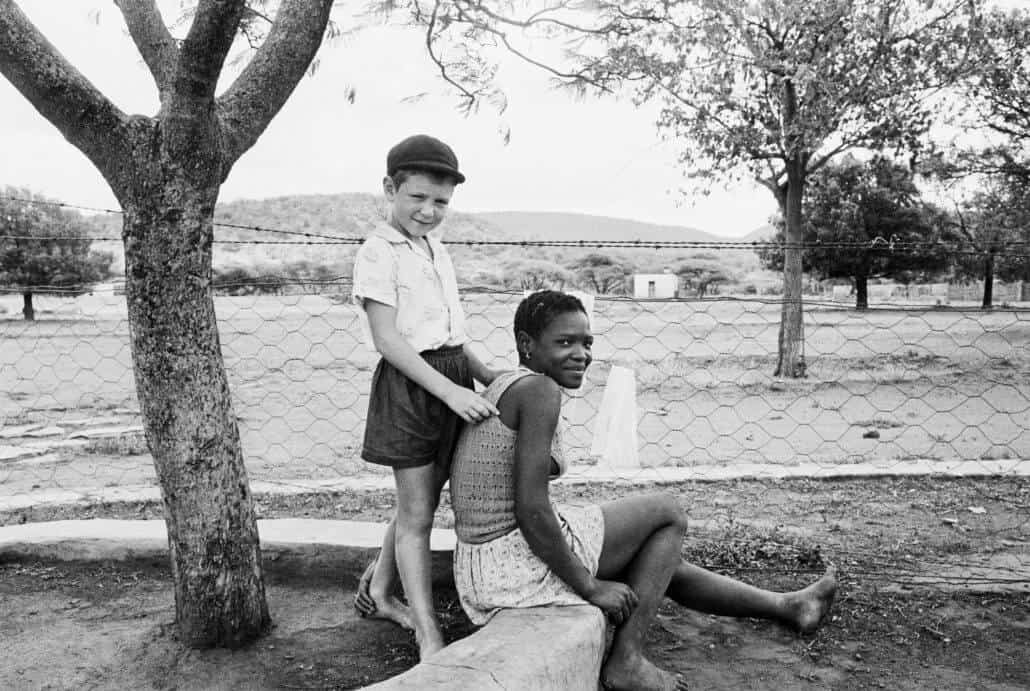 David Goldblatt. A farmer’s son with his nursemaid, Heimweeberg, Nietverdiend, Western Transvaal. 1964. Silver gelatin photograph on fibre-based paper. approx. 30 x 40cm. Courtesy of Goodman Gallery